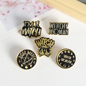 Detailed view of five witch-themed black and gold enamel pins with pentagram motifs