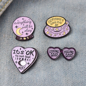 Macro shot of colorful enamel pins featuring heart and cup designs on denim fabric