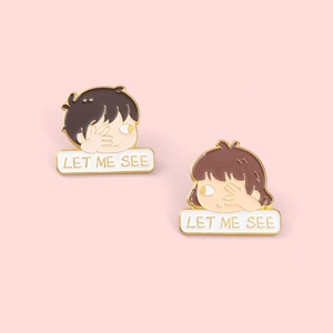 Cartoon couple enamel pins featuring boy and girl with LET ME SEE text in gold finish