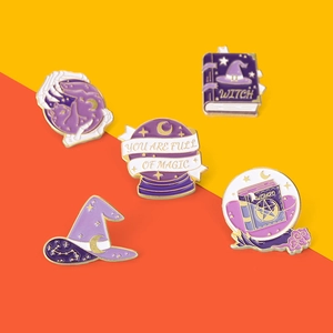Five pieces set of magic wizard enamel pins with witch hat and crystal ball on orange background