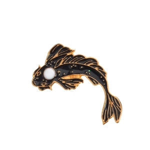Detailed view of an ornate koi fish enamel pin with gold metal outlines and black fill