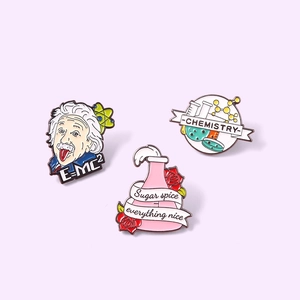 Three-piece enamel pin set featuring Einstein E=MC2 and chemistry laboratory themes