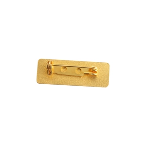 Macro view of golden metal brooch back with secure rotating safety pin clasp mechanism