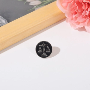 Enamel Libra scales pin with black and silver finish on elegant wooden frame