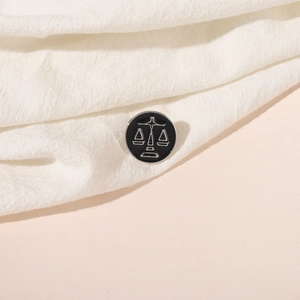 Minimalist black Libra zodiac enamel brooch with silver metal outlines on fabric