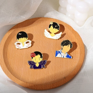 Set of 4 cute enamel cartoon boy lapel pins with angel wings and floral designs