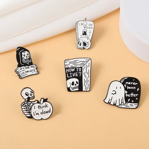 Collection of 5 punk gothic enamel pins with reaper and skull designs on warm background