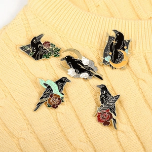 5pcs set of Gothic enamel crow pins with rose and moon motifs on a knit background