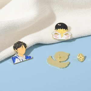 Detailed view of enamel cartoon brooch showing front design and gold butterfly clutch back