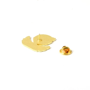 Detail view of the gold alloy pin back featuring a butterfly clasp and silhouette profile