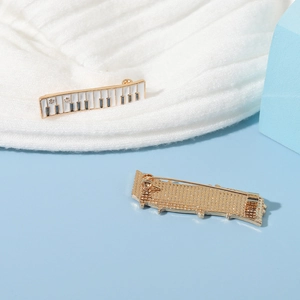 Cute piano keyboard enamel pin with musical cat motif and golden metal backing