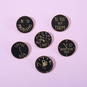 Set of 6 black enamel pins with gold trim featuring creative quotes and clock designs