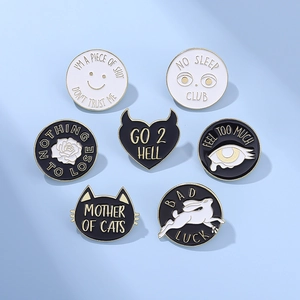 Set of 7 minimalist black and white enamel pins with cat and letter graphics