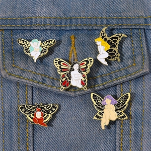 Exquisite set of five enamel moth and butterfly girl pins on a blue denim jacket pocket