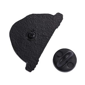 Detail view showing back of black enamel skull pin with secure rubber clutch backing