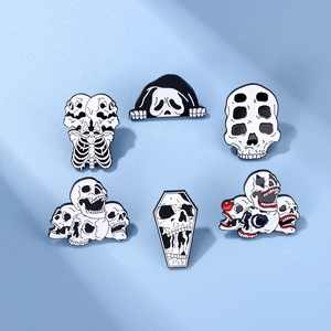Set of six punk horror style skull enamel pins with black and white gothic designs
