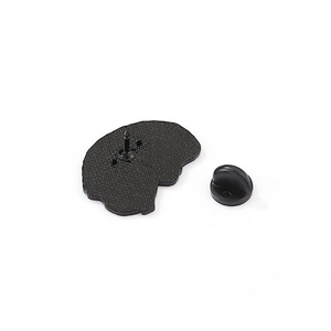 Detailed view of the back of a cartoon brain enamel pin with a black rubber clutch