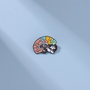 Macro detail of a colorful brain enamel pin with vibrant anatomy zones and metallic edge