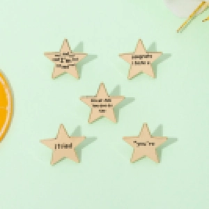 Set of five pentagram wooden badges with inspirational quotes on green background