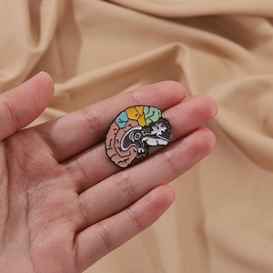 Close-up of a colorful brain anatomy enamel pin with vibrant colored sections