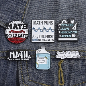 Set of 6 mathematical formula enamel pins with funny slogans on blue denim fabric