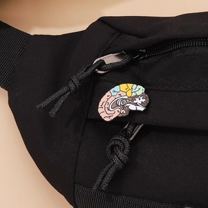 Close-up of a colorful brain enamel pin attached to a black nylon bag zipper accessory