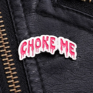 Detail of pink melting text enamel pin on black leather jacket with zipper textures