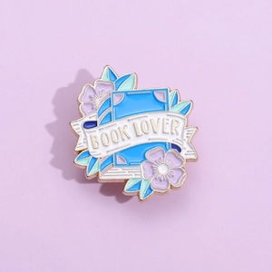 Book lover enamel pin with gold plating and floral decoration for bags and clothing