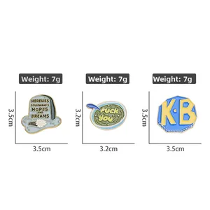 Three custom enamel pins including tombstone and KB logo designs for backpacks