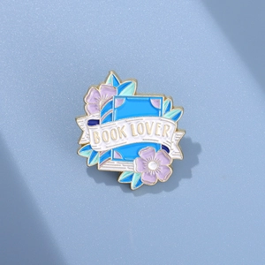 Artistic blue enamel book lover pin with purple flowers and golden metal edge