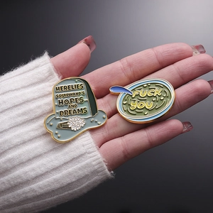Enamel tombstone and chat box lapel pins with Squidward hopes and dreams text