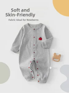 Detail view of grey cotton baby romper with apple embroidery and snaps for newborns