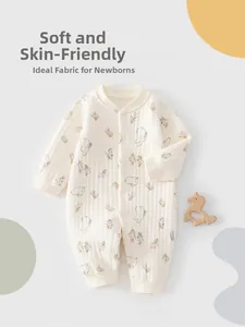 Close-up of soft cotton newborn romper with cute bunny and pink floral patterns