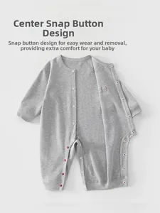 Detail of baby romper featuring snap button closure on soft grey knitted cotton fabric