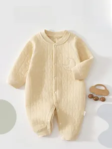 Detailed view of quilted cotton baby romper with moon stars pattern and snap buttons