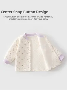 Detail of baby quilted cardigan with floral pattern and snap button closure for easy dressing