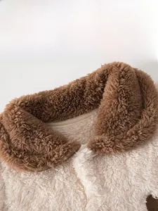 Detail of baby plush teddy fleece jumpsuit with soft turnover collar and warm texture