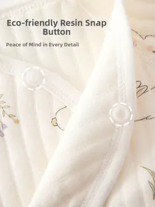 Detail view of cotton baby romper with eco-friendly resin snaps and floral bunny print