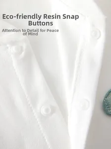 Macro detail of eco-friendly resin snap buttons on white knitted cotton baby bodysuit