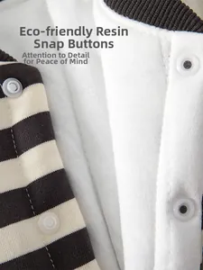 Detailed macro view of eco-friendly resin snaps and striped knit fabric on baby romper