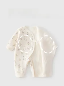 Detail of baby romper with warm double-layered belly guard and snap buttons for newborns