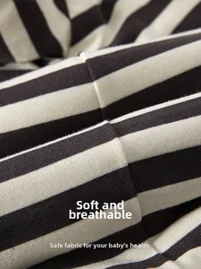 Close-up of soft striped cotton fabric with breathable texture for baby rompers