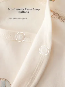 Close-up of eco-friendly resin snaps and soft combed cotton fabric on baby clothing