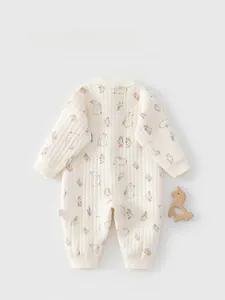 Detail view of newborn quilted cotton romper back featuring cute bunny and floral prints