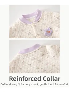 Close-up of quilted floral baby set showing purple ribbed neckline and snap buttons
