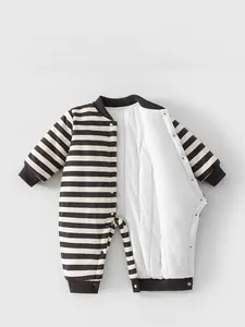 Detail showing the snap button closure and warm padded lining of the striped baby romper
