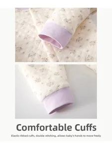 Detailed macro view of quilted floral baby pajamas with elastic ribbed cuffs and double stitching