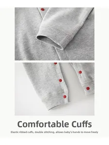 Detail of soft grey cotton baby romper with red snap buttons and ribbed cuffs for comfort