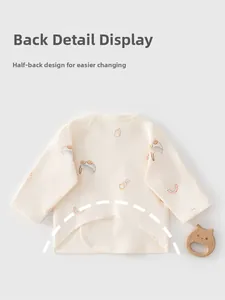 Detail of baby cotton top featuring half-back design for easy diaper changes and cartoon prints