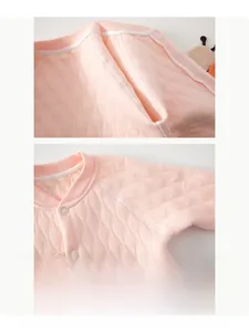 Détail d'une grenouillère matelassée rose avec coutures sans os et boutons à pression